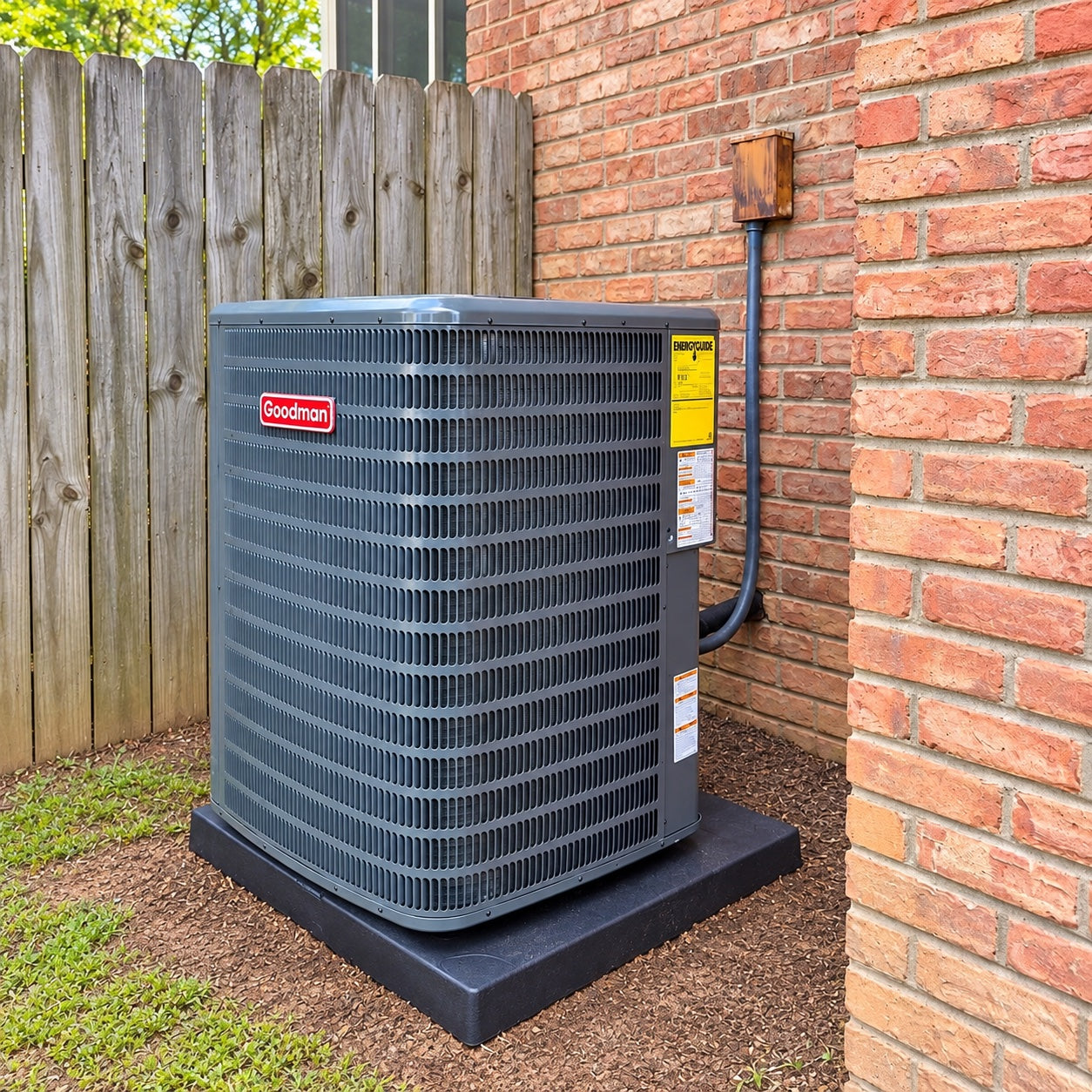 Goodman outdoor condenser beside a brick home